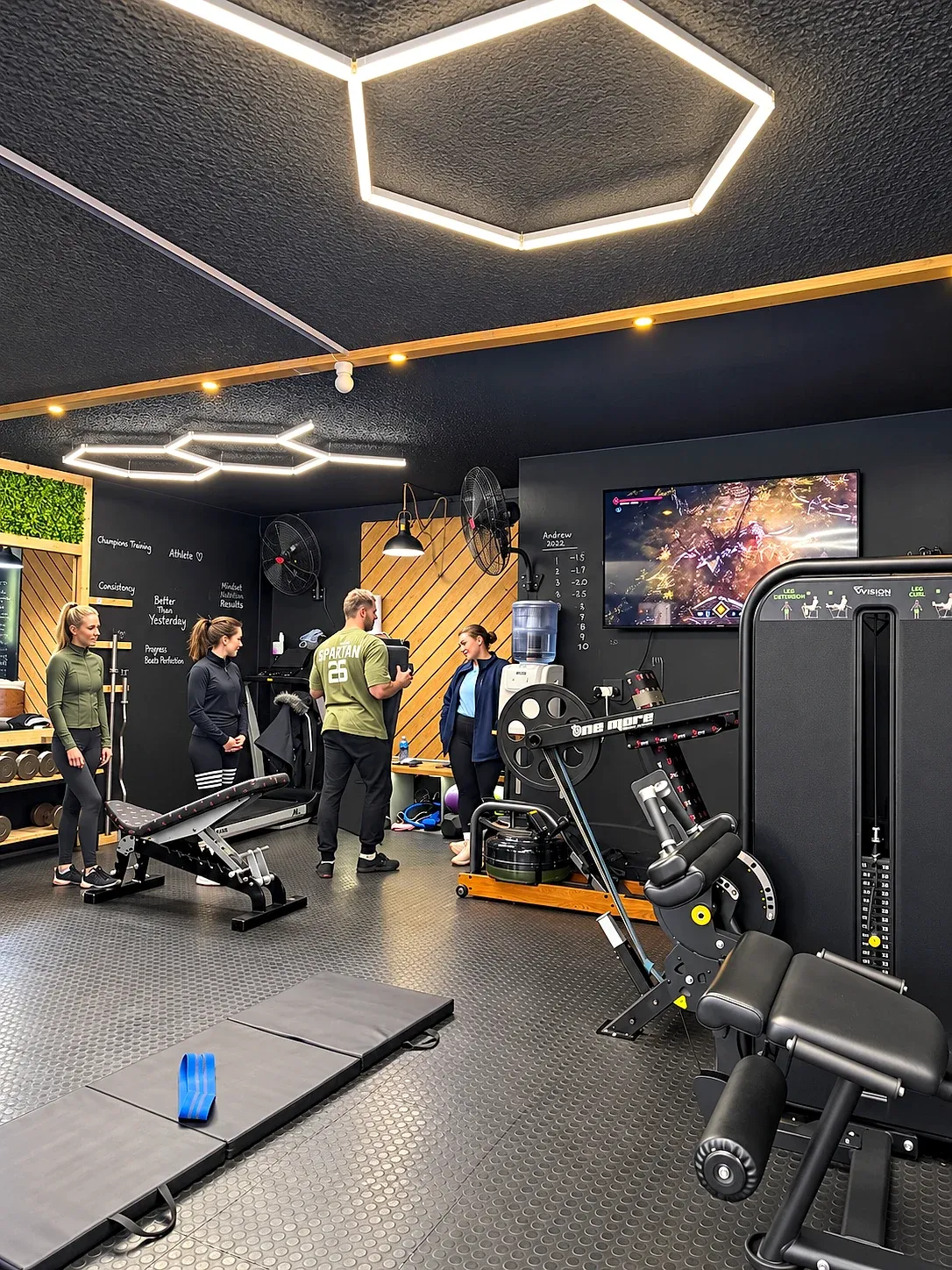 People and training equipment inside the XO Fit gym