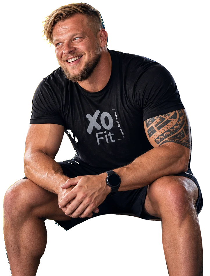 Wikus van Dyk, seated and smiling, wearing an XO Fit shirt